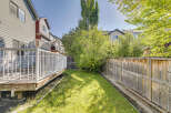 Enjoy outdoor living in this spacious backyard, complete with a large wooden deck perfect for entertaining.