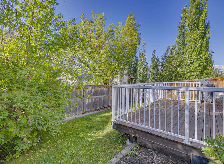 Enjoy outdoor living with this spacious wooden deck, perfect for entertaining or relaxing.
