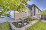 Charming single-family home featuring a welcoming front entrance with a covered porch and a two-car garage.