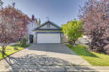 Charming single-family home featuring a spacious driveway leading to an attached garage.