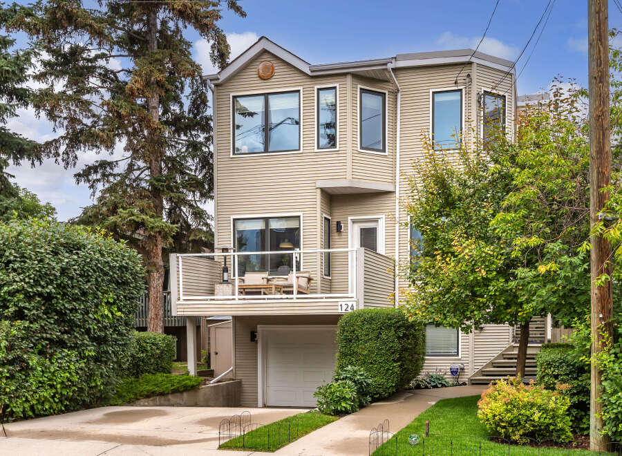 Discover this charming home featuring a spacious deck perfect for outdoor entertaining, complete with comfortable seating and a patio heater.