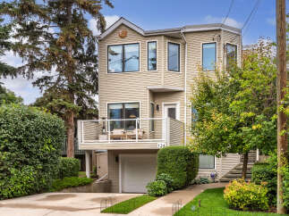 Discover this charming home featuring a spacious deck perfect for outdoor entertaining, complete with comfortable seating and a patio heater.