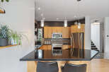 Discover this stunning kitchen featuring sleek granite countertops and warm wood cabinetry, perfect for culinary enthusiasts.