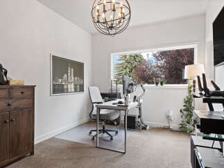 This home office features a modern desk setup with dual monitors and a comfortable ergonomic chair, perfect for productivity.
