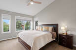 Experience comfort and style in this beautifully appointed bedroom, featuring a spacious king-size bed with a dark wood headboard and plush decorative pillows.