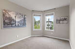 This spacious room features a large black and white cityscape artwork on the left wall and a dynamic horse-themed artwork on the right.