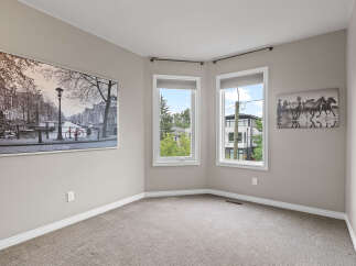 This spacious room features a large black and white cityscape artwork on the left wall and a dynamic horse-themed artwork on the right.