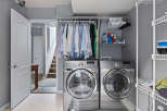This laundry room features a stacked Samsung washer and dryer set, perfect for maximizing space.