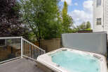 Relax and unwind in this luxurious backyard oasis, featuring a spacious hot tub perfect for year-round enjoyment.