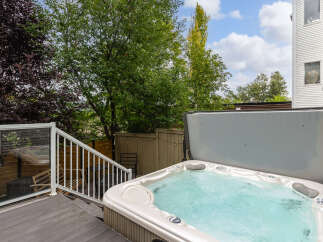 Relax and unwind in this luxurious backyard oasis, featuring a spacious hot tub perfect for year-round enjoyment.