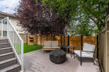Enjoy outdoor living on this spacious deck featuring comfortable seating and a fire pit, perfect for gatherings.