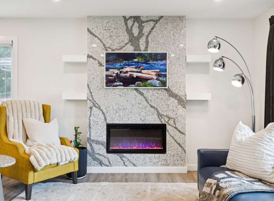 Experience modern living with this stunning fireplace featuring a unique granite surround and a vibrant electric fire.