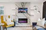 Experience modern living with this stunning fireplace featuring a unique granite surround and a vibrant electric fire.