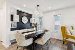 This elegant dining room features a sleek black marble-top dining table with modern chairs, perfect for hosting gatherings.