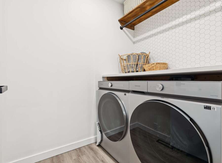 This modern laundry room features a sleek Samsung washer and dryer set, perfect for handling large loads.