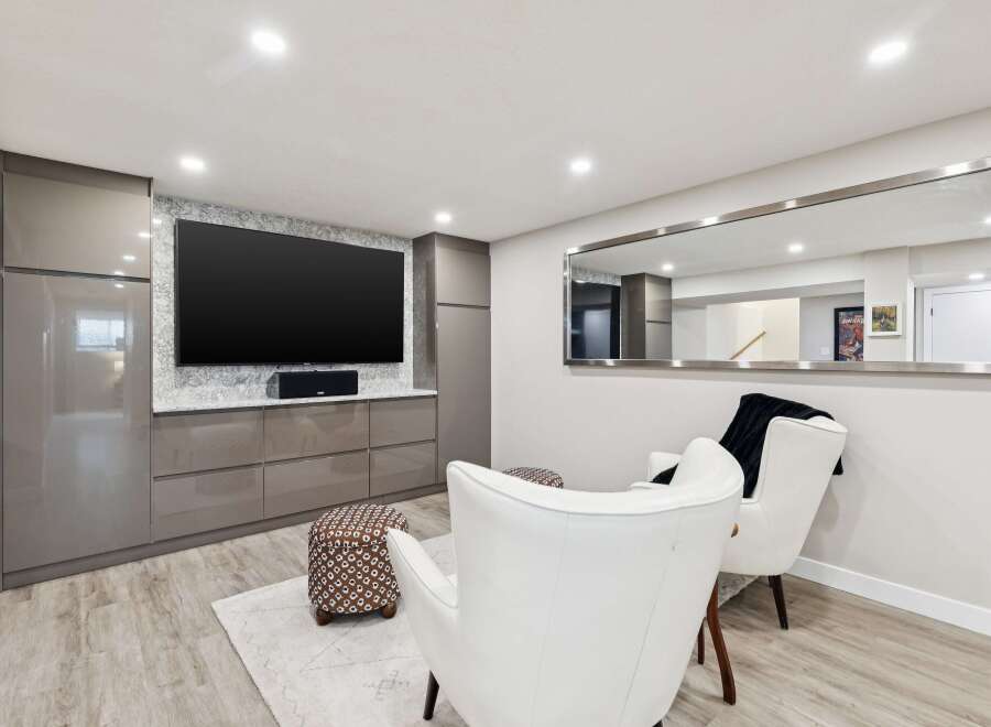 This modern living space features a sleek entertainment center with ample storage and a large flat-screen TV, perfect for movie nights.