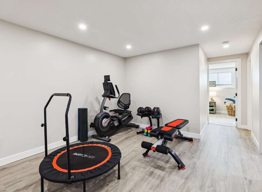 This home features a dedicated home gym space, perfect for maintaining your fitness routine without leaving the house.