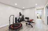 This home features a dedicated home gym space, perfect for maintaining your fitness routine without leaving the house.