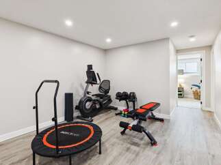 This home features a dedicated home gym space, perfect for maintaining your fitness routine without leaving the house.