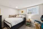 This charming bedroom features a comfortable queen-size bed with crisp white linens, perfect for a restful night's sleep.