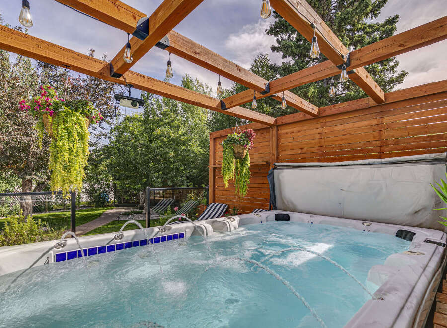 Experience ultimate relaxation in this backyard oasis, featuring a luxurious hot tub perfect for unwinding.