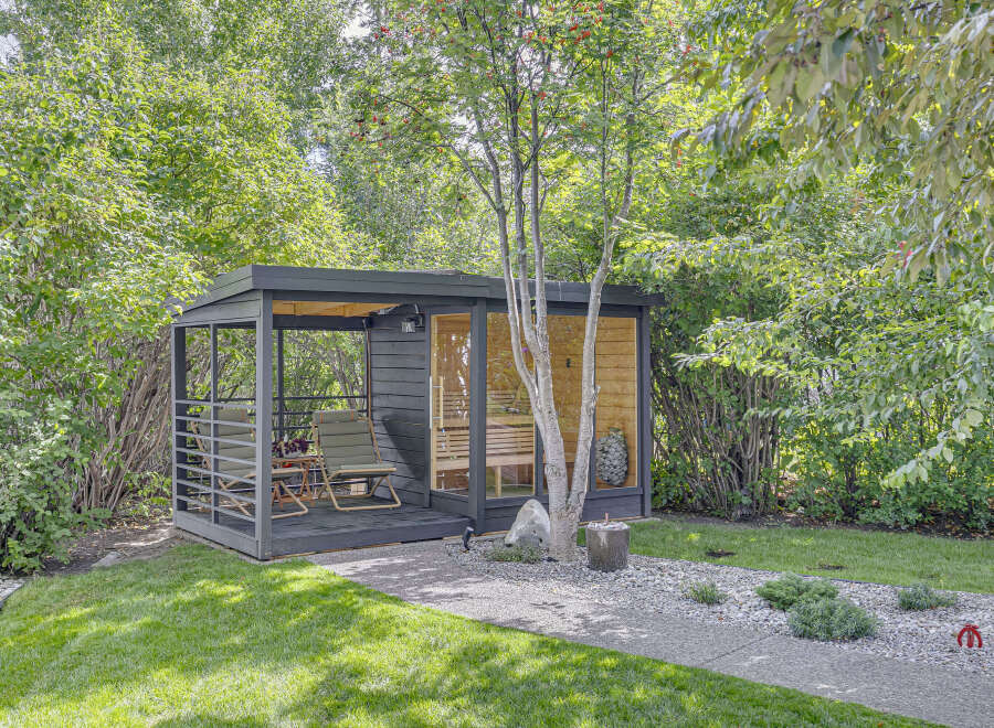 Discover this modern backyard oasis featuring a sleek, dark-finished sauna cabin with large glass windows, offering a private retreat.