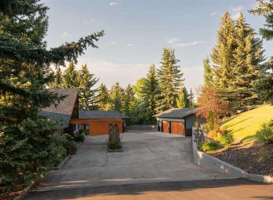 Nestled amidst mature evergreen trees, this property offers a serene and private retreat.