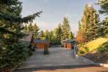 Nestled amidst mature evergreen trees, this property offers a serene and private retreat.