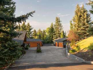 Nestled amidst mature evergreen trees, this property offers a serene and private retreat.