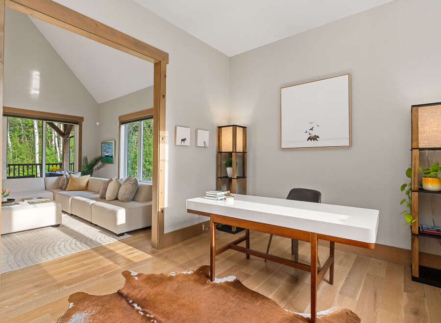 Discover this inviting home office space featuring a sleek white desk and a cozy cowhide rug, perfect for productivity.