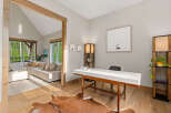 Discover this inviting home office space featuring a sleek white desk and a cozy cowhide rug, perfect for productivity.