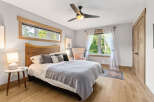 Experience serene comfort in this inviting bedroom, featuring a plush king-sized bed adorned with soft linens and decorative pillows.