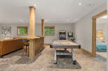 This finished basement offers the ultimate entertainment space, featuring a full-size air hockey table and classic arcade games.