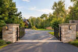 Welcome to this stunning property through elegant stone pillars and wrought iron gates.
