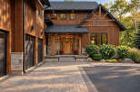 This stunning custom-built home features a beautiful blend of natural wood siding and stone accents, creating a warm and inviting lodge-like aesthetic.
