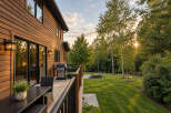 Enjoy outdoor living at its finest with this stunning property featuring a spacious wooden deck perfect for entertaining.