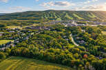 Experience the beauty of autumn in this stunning aerial view of a residential area nestled amongst vibrant fall foliage.
