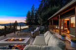 Experience breathtaking sunset views from this stunning deck, complete with a modern fire pit and comfortable seating.
