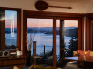 Experience breathtaking sunset views over the water from this stunning property.