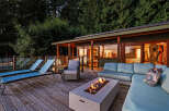 Experience ultimate relaxation on this stunning deck, featuring a modern fire pit and comfortable lounge seating perfect for evening gatherings.