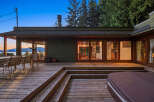 Enjoy breathtaking sunset views from this expansive wooden deck, complete with an outdoor dining area and a relaxing hot tub.