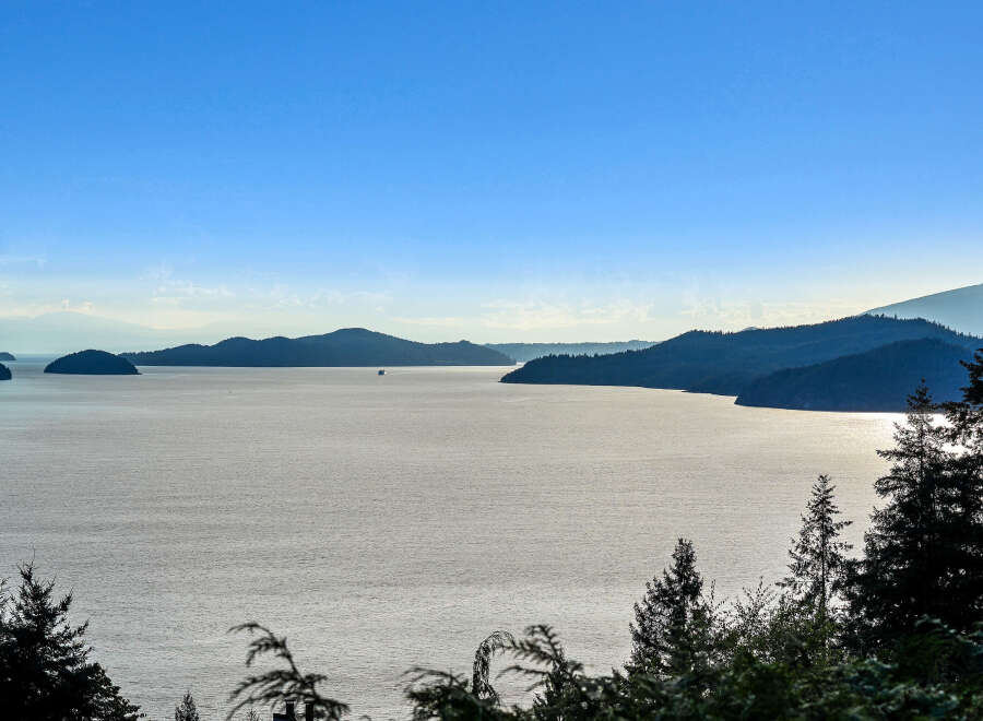 Experience breathtaking panoramic views of the serene ocean and lush, tree-lined islands from this stunning vantage point.