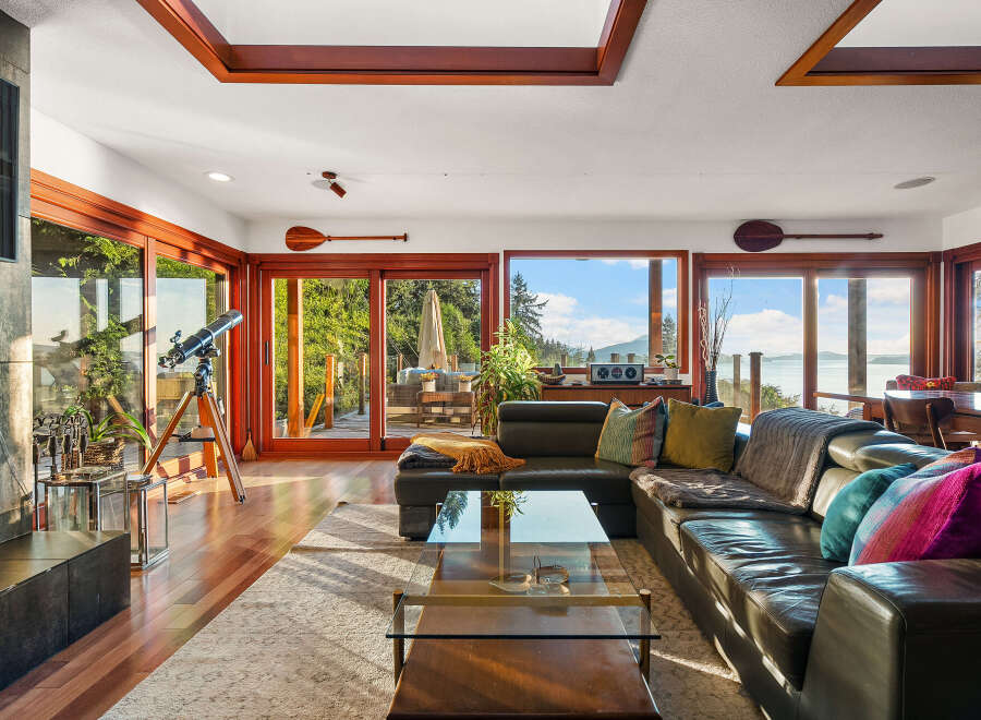 Experience breathtaking ocean views from this stunning living room, featuring a large sectional sofa perfect for relaxing.
