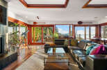 Experience breathtaking ocean views from this stunning living room, featuring a large sectional sofa perfect for relaxing.