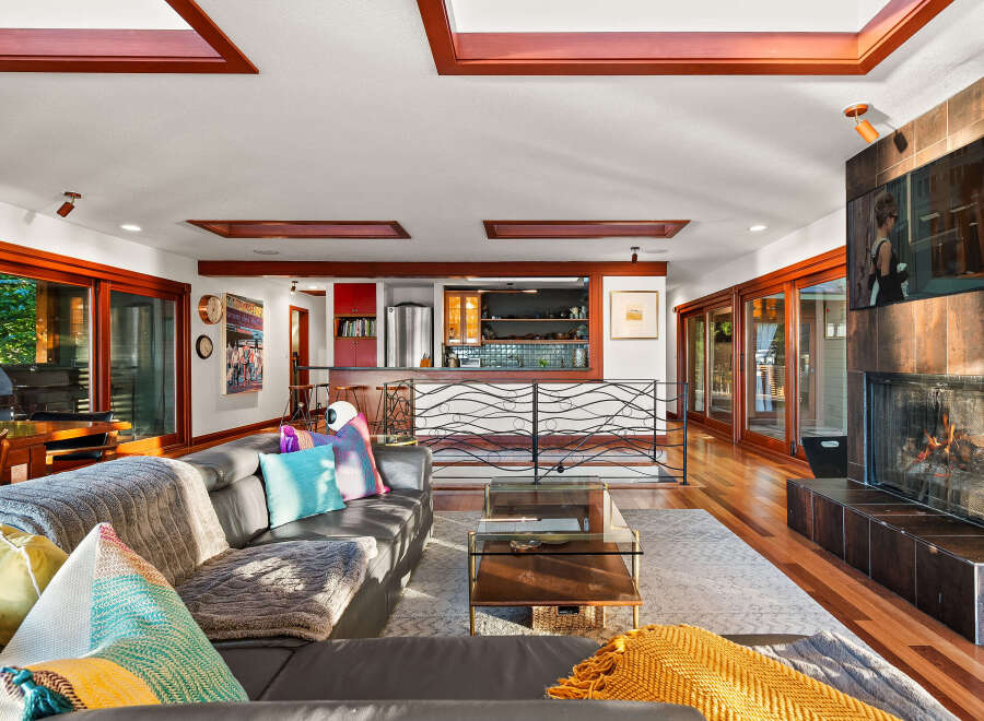 Experience luxurious living in this stunning home featuring a modern living room with a cozy fireplace and a sleek entertainment center.