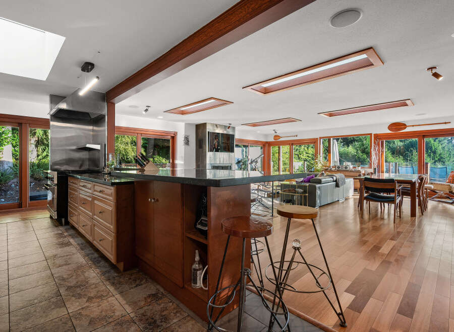 Experience seamless indoor-outdoor living in this stunning open-concept home, featuring a gourmet kitchen with a large island and stainless steel appliances.
