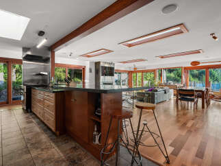 Experience seamless indoor-outdoor living in this stunning open-concept home, featuring a gourmet kitchen with a large island and stainless steel appliances.