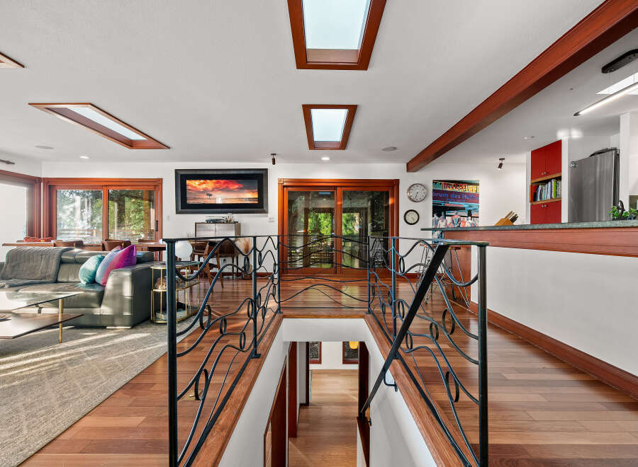 Experience luxurious living in this stunning home featuring a spacious open-concept living area with large windows and skylights that flood the space with natural light.