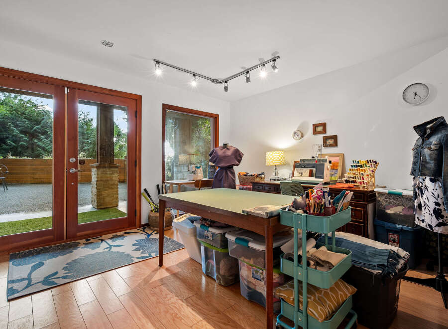 Unleash your creativity in this dedicated craft room, featuring a spacious cutting table and ample storage solutions.