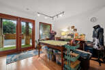 Unleash your creativity in this dedicated craft room, featuring a spacious cutting table and ample storage solutions.